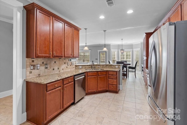 kitchen with pendant lighting, backsplash, sink, kitchen peninsula, and stainless steel appliances