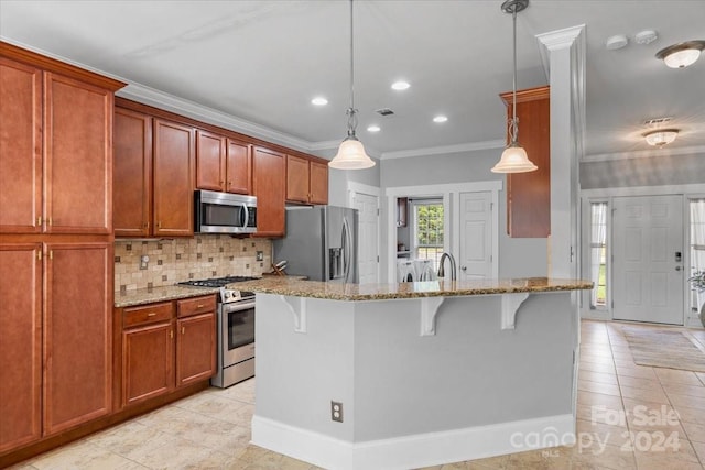 kitchen with light stone countertops, a breakfast bar, stainless steel appliances, crown molding, and decorative light fixtures