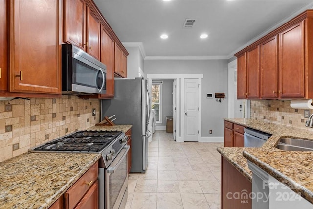 kitchen featuring crown molding, sink, tasteful backsplash, light stone counters, and stainless steel appliances