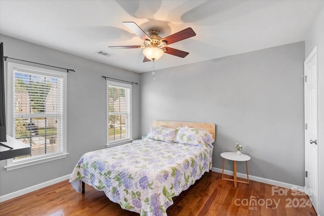 bedroom featuring dark hardwood / wood-style flooring and ceiling fan