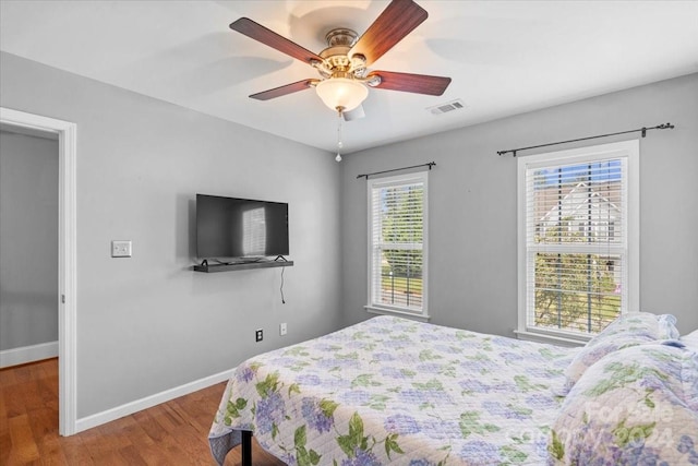 bedroom with ceiling fan and hardwood / wood-style flooring