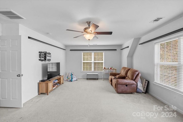 sitting room featuring carpet floors, a wealth of natural light, and ceiling fan