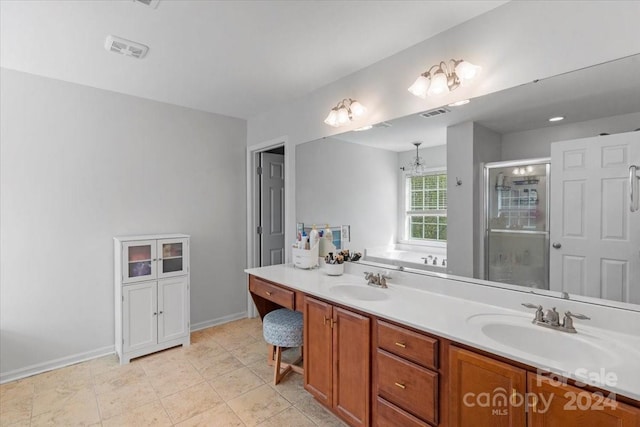 bathroom with plus walk in shower, vanity, and an inviting chandelier