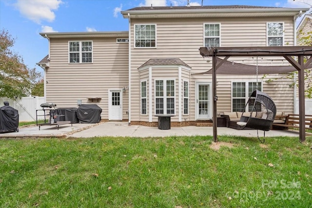 rear view of property featuring a yard, a patio, an outdoor living space, and a pergola