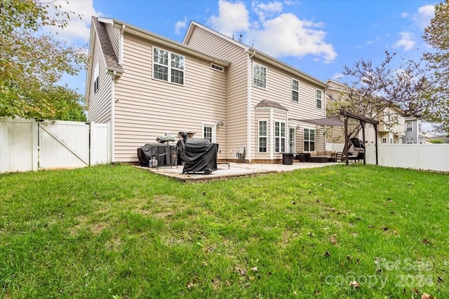 rear view of house featuring a yard and a patio