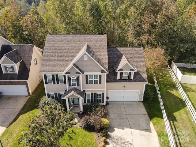 view of front of house with a garage and a front lawn