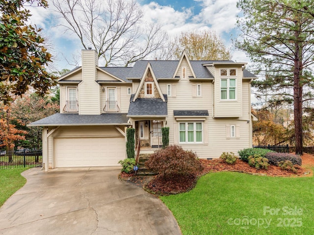 view of front of property featuring a garage and a front yard