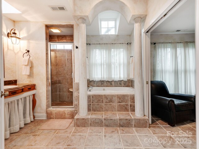 bathroom featuring a stall shower, tiled bath, visible vents, and ornate columns