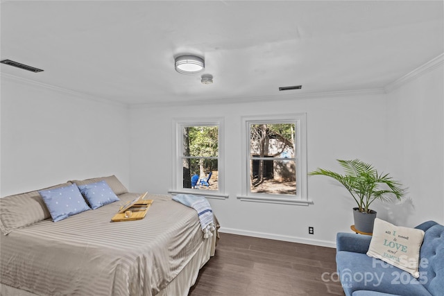 bedroom with crown molding and dark wood-type flooring