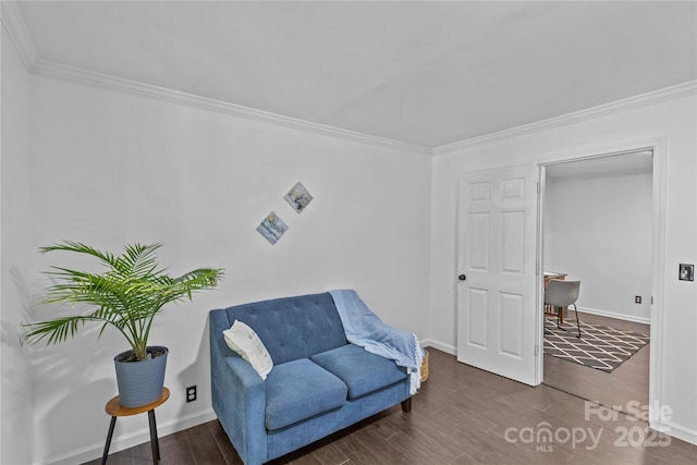 sitting room with dark hardwood / wood-style flooring and ornamental molding