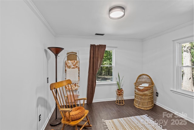 sitting room with dark hardwood / wood-style floors and ornamental molding