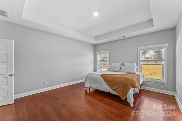 3157 Delaware Dr, Denver, NC 28037 - bedroom with visible vents, wood finished floors, multiple windows, and a tray ceiling