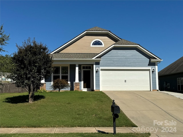 3157 Delaware Dr, Denver, NC 28037 - view of front facade featuring driveway, roof with shingles, a front yard, fence, and a garage