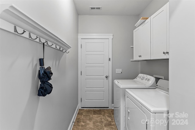 3157 Delaware Dr, Denver, NC 28037 - laundry area featuring washer and dryer, cabinet space, stone finish floor, baseboards, and visible vents