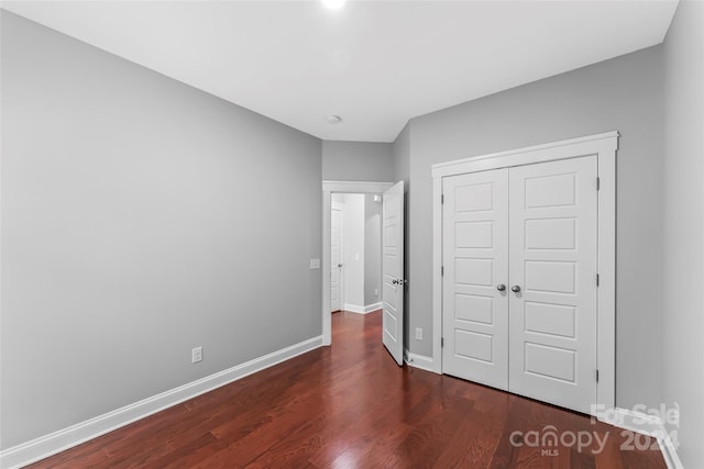 3157 Delaware Dr, Denver, NC 28037 - unfurnished bedroom featuring dark wood-style floors, a closet, and baseboards