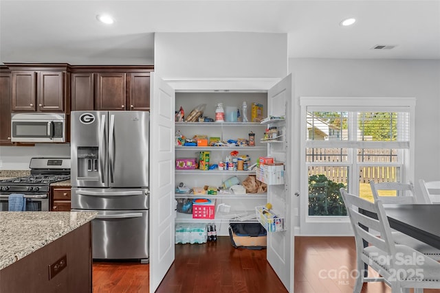 3157 Delaware Dr, Denver, NC 28037 - kitchen featuring stainless steel appliances, dark wood finished floors, light stone countertops, dark brown cabinets, and recessed lighting