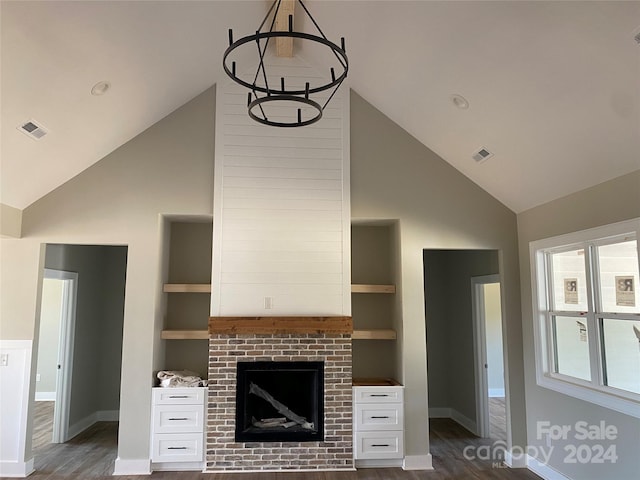 unfurnished living room featuring a fireplace, dark hardwood / wood-style flooring, built in features, and lofted ceiling