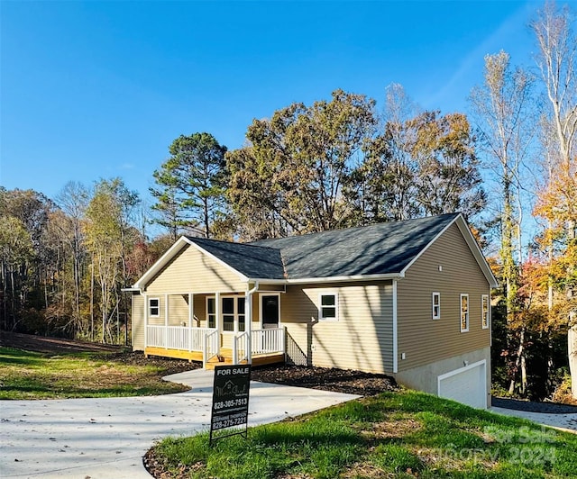 single story home featuring a porch and a garage