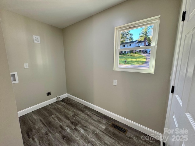 washroom with washer hookup, visible vents, dark wood-type flooring, laundry area, and baseboards