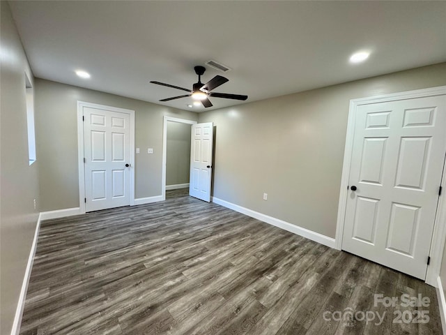 unfurnished bedroom with dark wood-style floors, recessed lighting, visible vents, and baseboards