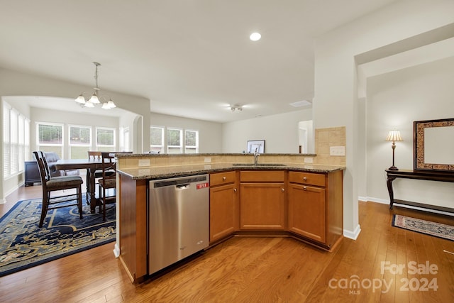 kitchen featuring an inviting chandelier, light hardwood / wood-style flooring, stainless steel dishwasher, and sink