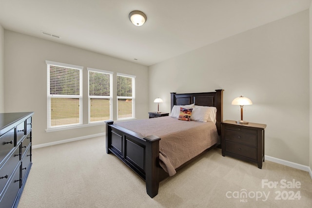 bedroom with light colored carpet