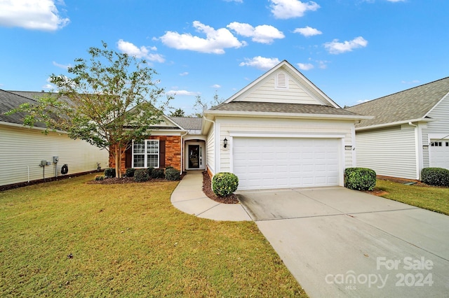 view of front of house featuring a garage and a front yard