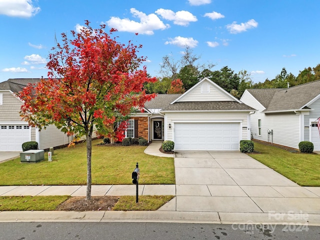 view of front of home featuring a garage and a front lawn