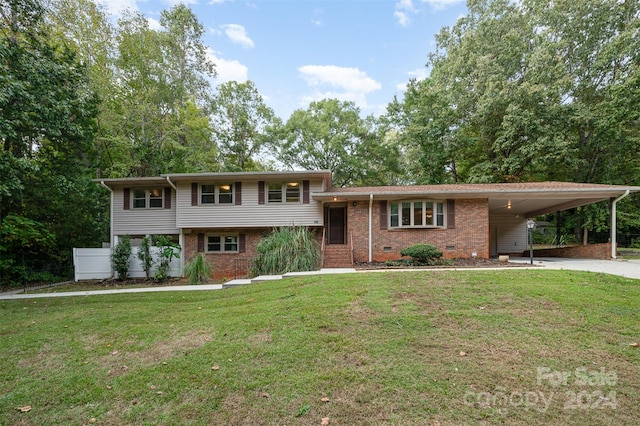 tri-level home with a front lawn and a carport