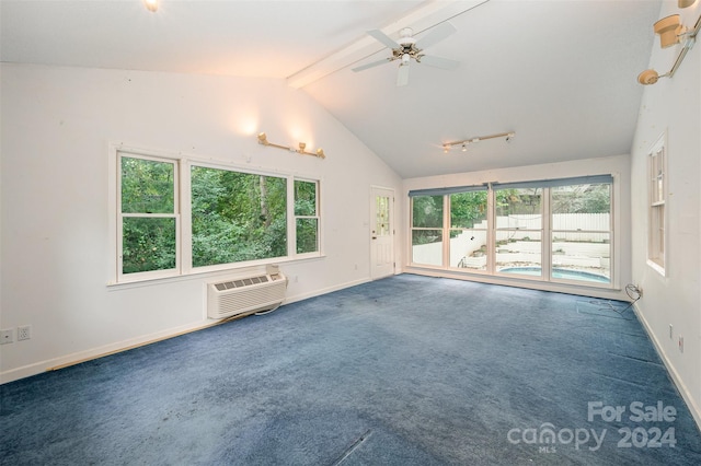 empty room featuring a wall mounted AC, a healthy amount of sunlight, beamed ceiling, and carpet