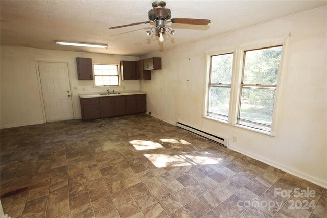 521 Short St Unit 8, Morven, NC 28119 - kitchen featuring baseboard heating, a ceiling fan, light countertops, a sink, and a textured ceiling