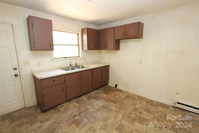 521 Short St Unit 8, Morven, NC 28119 - kitchen with a sink, light countertops, a baseboard radiator, and stone finish floors