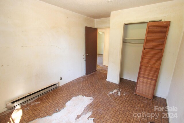 521 Short St Unit 8, Morven, NC 28119 - unfurnished bedroom featuring a baseboard radiator and a closet