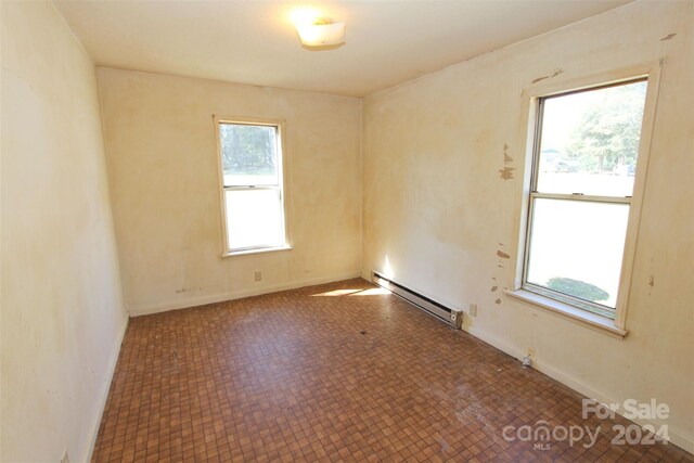 521 Short St Unit 8, Morven, NC 28119 - empty room with baseboard heating, baseboards, and tile patterned floors
