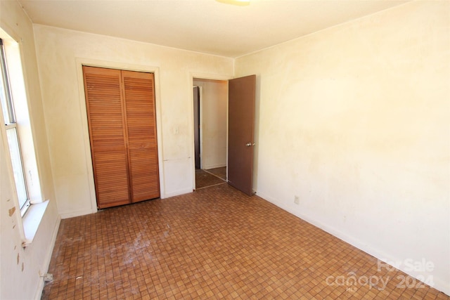 521 Short St Unit 8, Morven, NC 28119 - unfurnished bedroom with a closet, baseboards, and tile patterned floors