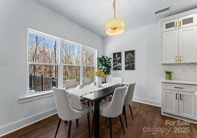 dining room with a chandelier and dark wood-type flooring