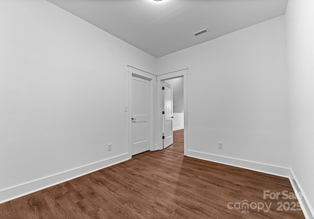 unfurnished room featuring dark hardwood / wood-style floors