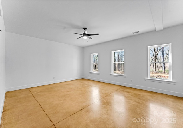 unfurnished room featuring concrete floors, a wealth of natural light, and ceiling fan