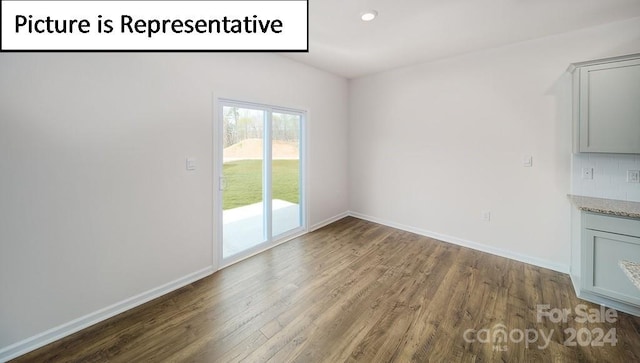 unfurnished living room with dark hardwood / wood-style flooring