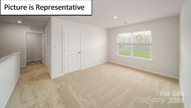 unfurnished room with light carpet