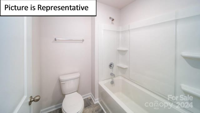 bathroom with hardwood / wood-style floors, washtub / shower combination, and toilet