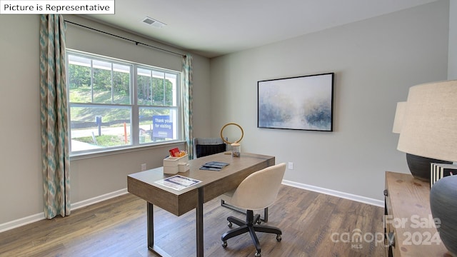 office space with dark wood-type flooring