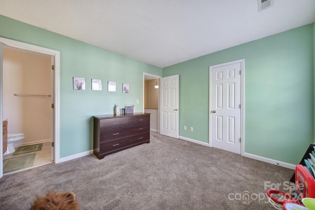 carpeted bedroom with ensuite bath