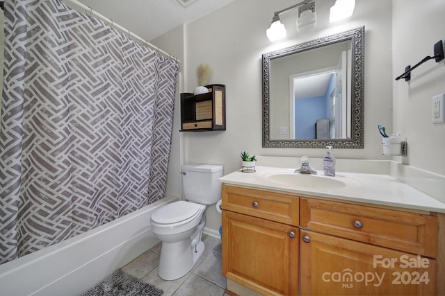 full bathroom featuring tile patterned floors, toilet, shower / tub combo, vanity, and a textured ceiling