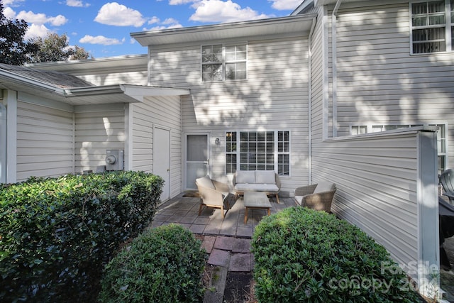 exterior space featuring an outdoor hangout area and a patio area