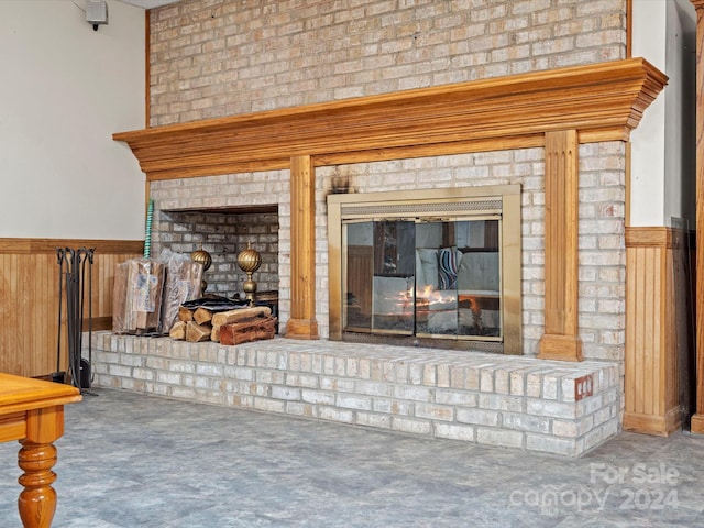 interior details featuring a fireplace and wooden walls