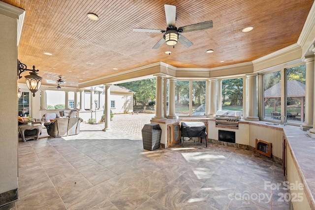 interior space with a sink, an outdoor kitchen, a grill, and a ceiling fan