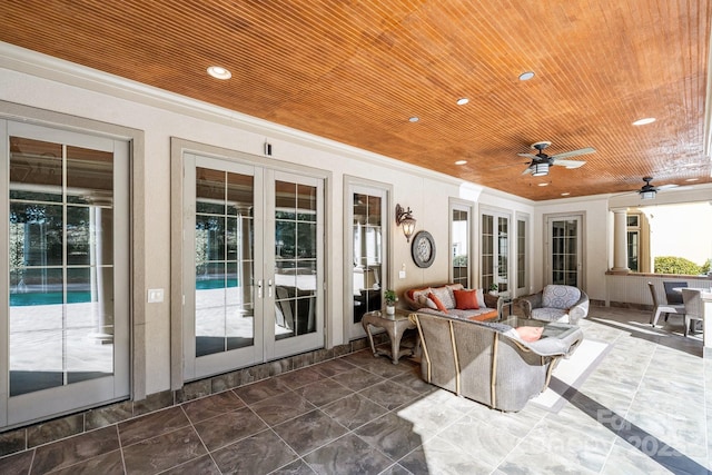 sunroom with wooden ceiling, a ceiling fan, and french doors