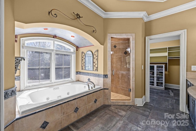 bathroom featuring a stall shower, baseboards, a whirlpool tub, a spacious closet, and crown molding