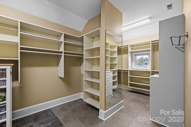 spacious closet featuring visible vents